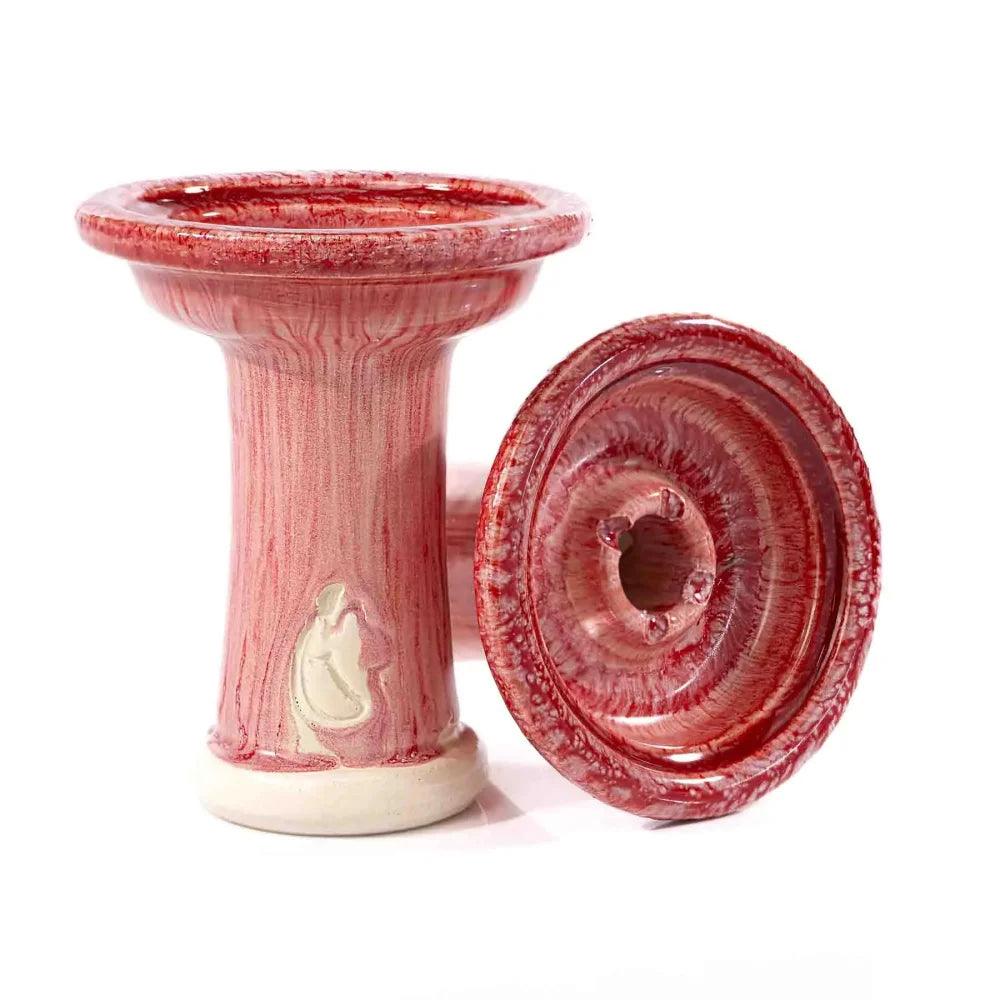 Dschinni Shisha Phunnel Royal Schamottstein Rojo in rot/pink. Es ist ein stehender und ein liegender Phunnel abgebildet. Das Dschinni Symbol ist zu sehen.